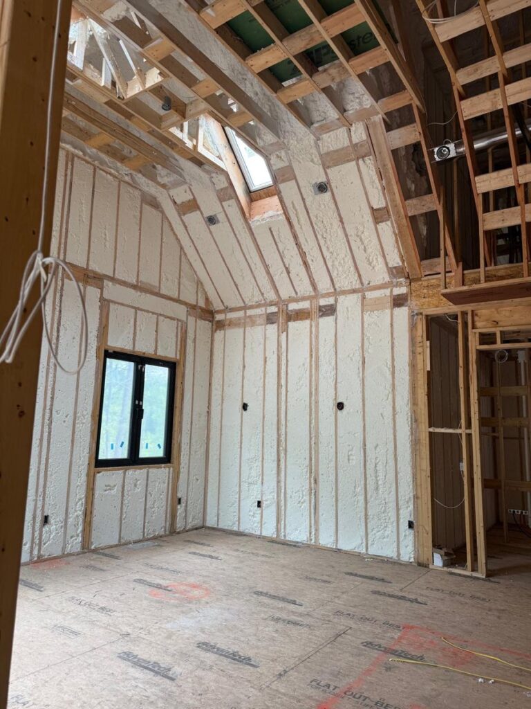 Spray foam insulation around a skylight and sloped dormer ceiling