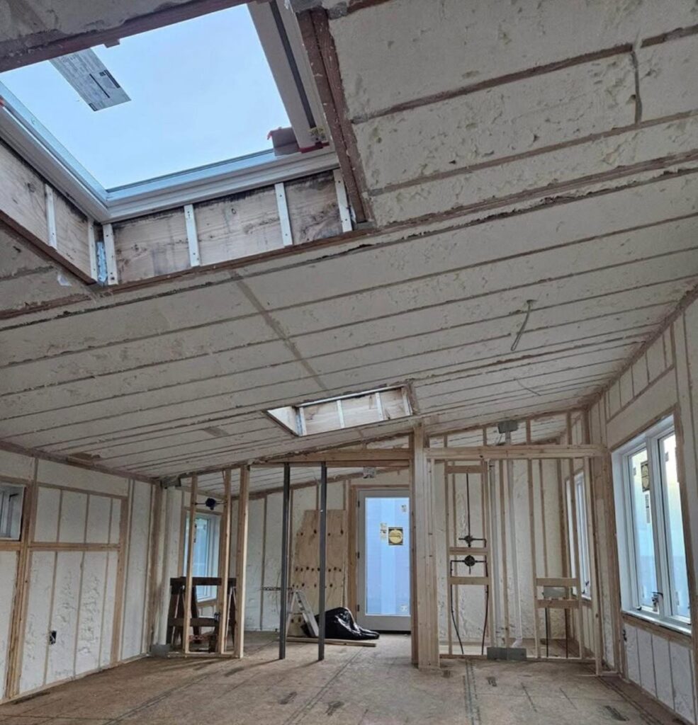 Spray-foamed ceiling around two skylights in an open-plan room