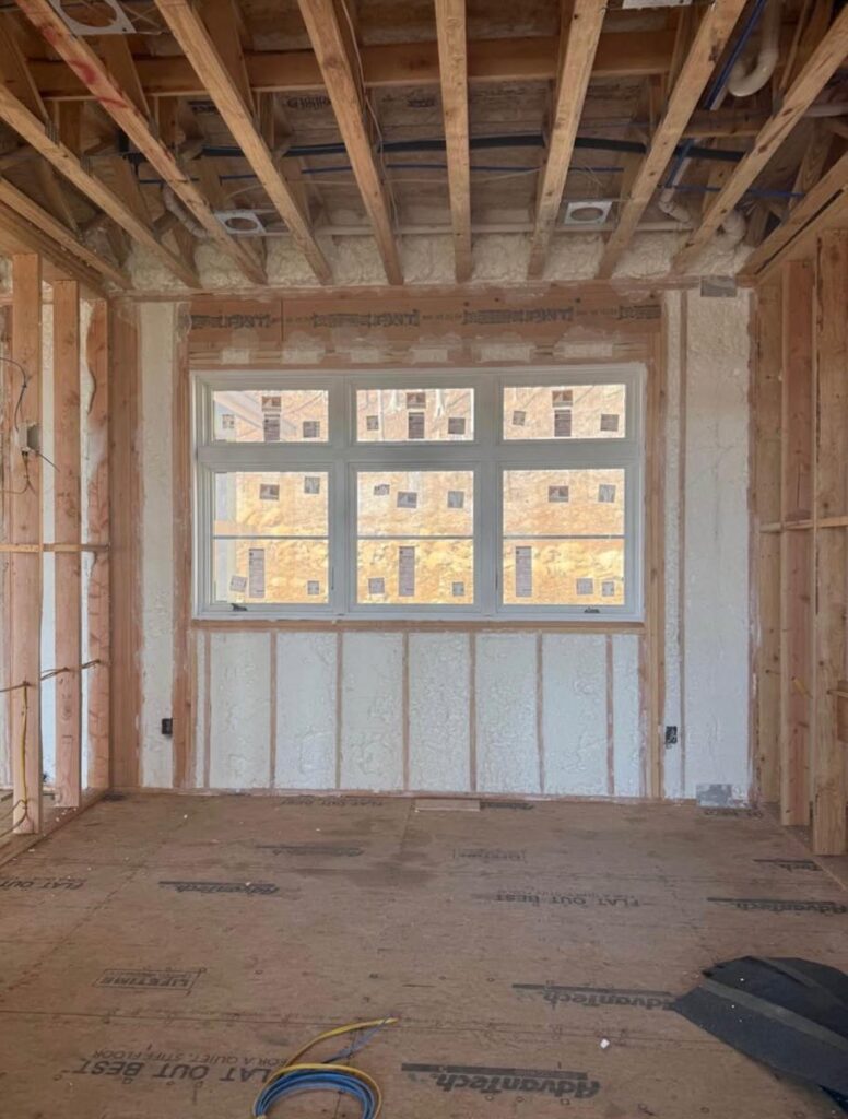 Spray foam insulation packed tight around a bay window opening