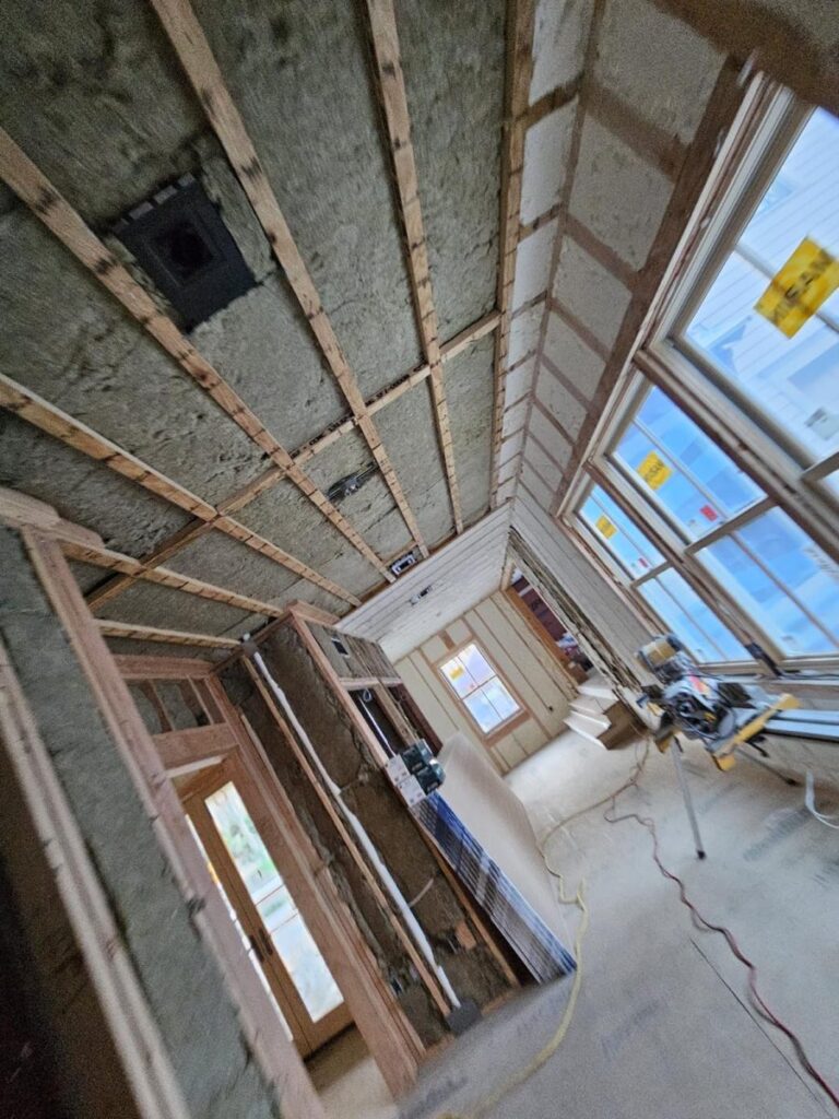 Mineral wool batts fitted between ceiling joists and wall studs