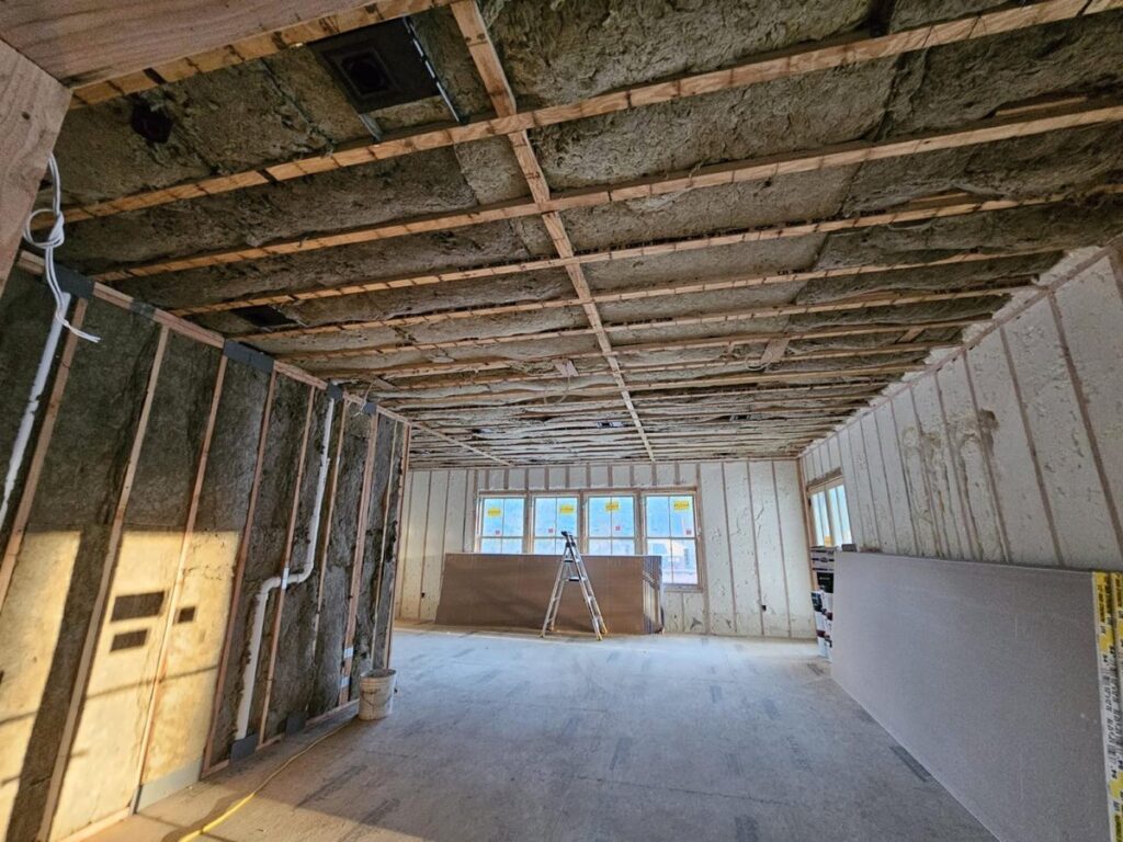 Mineral wool batt insulation across a ceiling and side walls