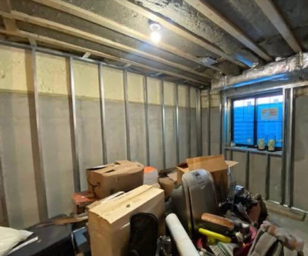 Insulated basement wall behind steel stud framing